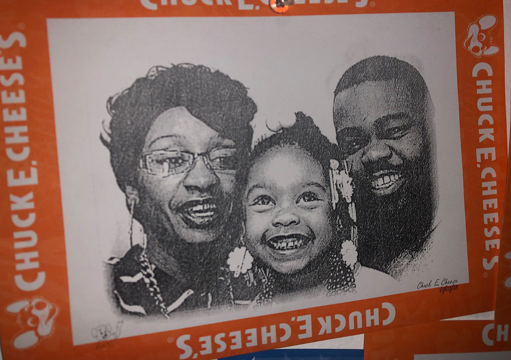 A picture of Houston and Hargrove, with their daughter, Chunk hangs on her wall